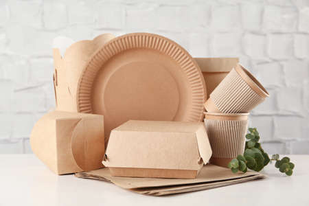 Disposable eco friendly products on white wooden table