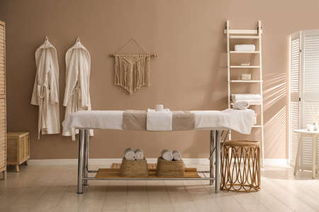 Stylish spa salon interior with massage tableの写真素材