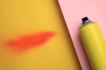 Can of graffiti paint and sprayed dye sample on color background, top viewの写真素材