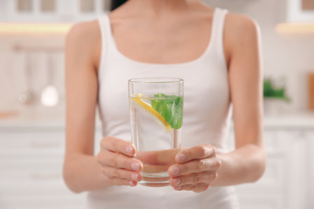 Young woman with glass of fresh lemonade at home, closeupの写真素材