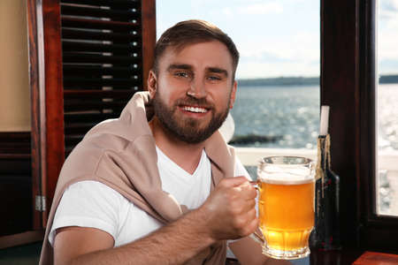 Man with glass of tasty beer in pubの写真素材
