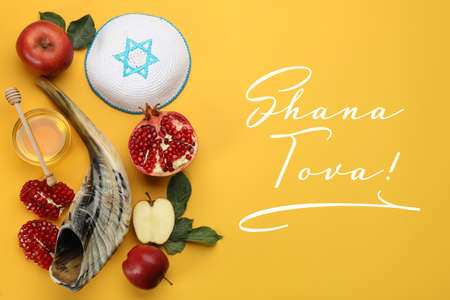 Flat lay composition with Rosh Hashanah holiday attributes on yellow backgroundの写真素材
