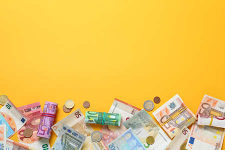 Money on yellow background, flat lay. Space for textの写真素材