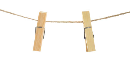 Two wooden clothespins on rope against white backgroundの写真素材