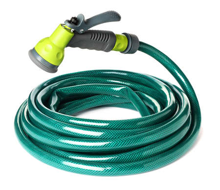 Green rubber watering hose with nozzle isolated on whiteの写真素材