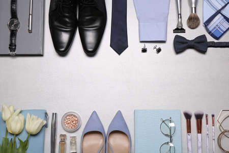 Flat lay composition with fashionable woman's and man's accessories on light background. Space for textの写真素材