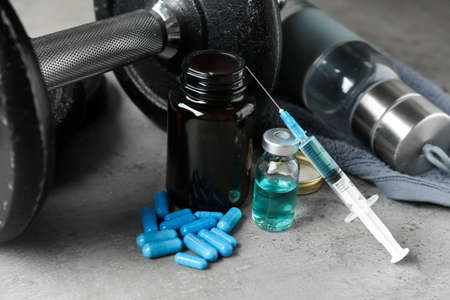 Different drugs and sports equipment on gray background. Doping controlの写真素材