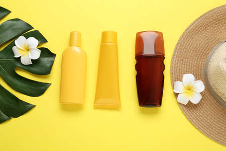 Sun protection products, hat and beach items on yellow background, flat layの写真素材