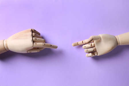 Wooden mannequin hands on lilac background, flat layの写真素材