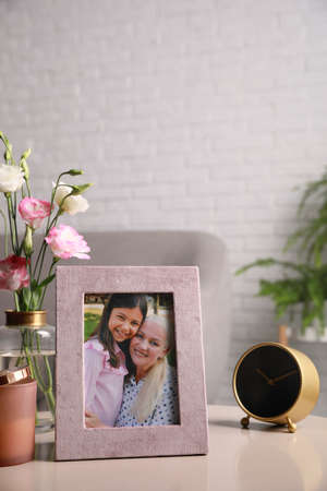 Framed family photo on light table in living room
