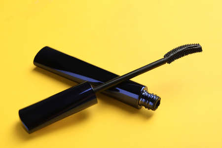 Mascara for eyelashes on yellow background, closeup. Makeup productの写真素材