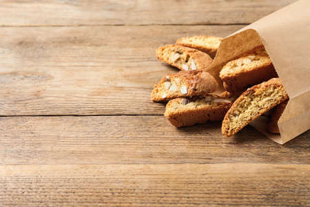 Traditional Italian almond biscuits (Cantucci) on wooden table, space for textの写真素材