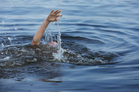Drowning woman reaching for help in sea, closeup