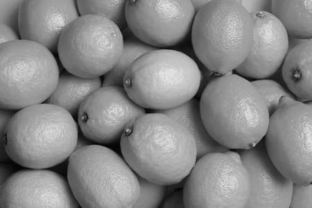Many fresh lemons as background, top view. Black and white toneの写真素材