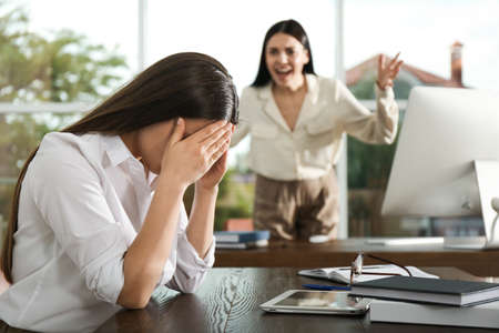 Boss screaming at employee in office. Toxic work environmentの写真素材