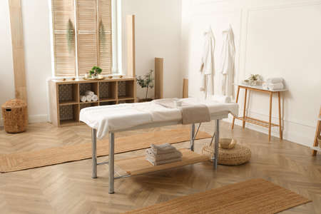 Stylish massage room interior with spa table in salonの写真素材