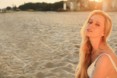 Beautiful young woman on sandy beach, space for textの写真素材