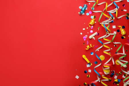 Flat lay composition with carnival items on red background. Space for text