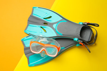 Pair of flippers and diving mask on color background, flat layの写真素材