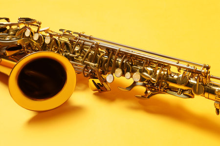 Beautiful saxophone on yellow background, closeup viewの写真素材