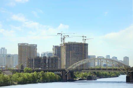 Beautiful view of cityscape with modern buildings and bridge over riverの写真素材