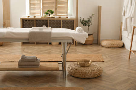 Stylish massage room interior with spa table in salonの写真素材