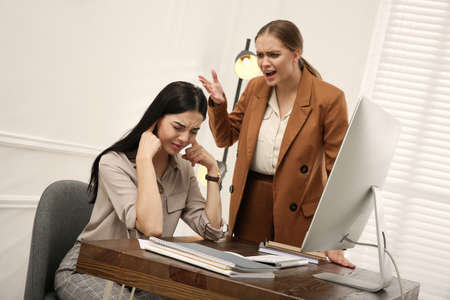 Boss screaming at employee in office. Toxic work environmentの写真素材