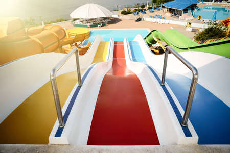 Colorful slides in water park on sunny day