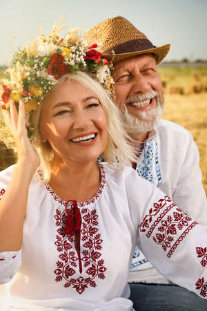 Happy mature couple wearing Ukrainian national clothes in fieldの写真素材