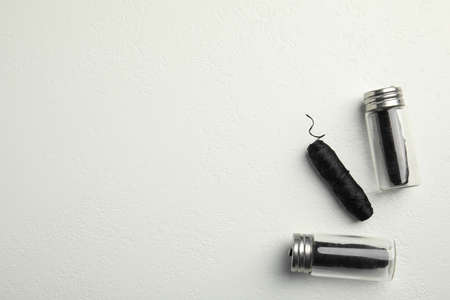 Biodegradable dental flosses on white background, flat lay. Space for textの写真素材