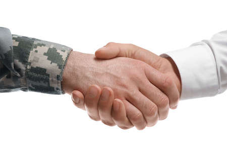 Soldier and businessman shaking hands against white background, closeupの写真素材