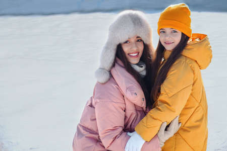 Mother and daughter spending time together at outdoor ice skating rinkの写真素材