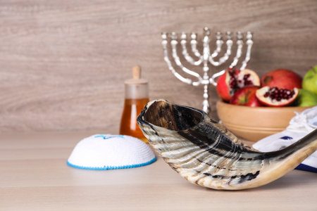 Shofar and other Rosh Hashanah holiday attributes on wooden table.の写真素材