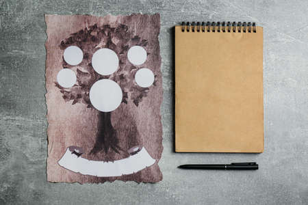 Blank family tree, notebook and pen on gray table, flat lay. Mockup for design