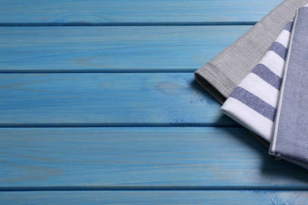 Different kitchen towels on blue wooden table. Space for textの写真素材