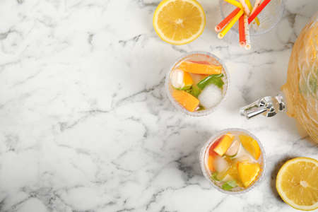 Delicious refreshing drink with orange and grapefruit on white marble table, flat lay. Space for textの写真素材
