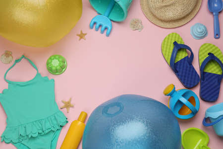 Composition with beach balls and sand toys on pink background, flat lay. Space for text