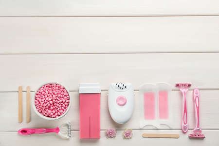 Set of epilation products on white wooden table, flat lay. Space for textの写真素材