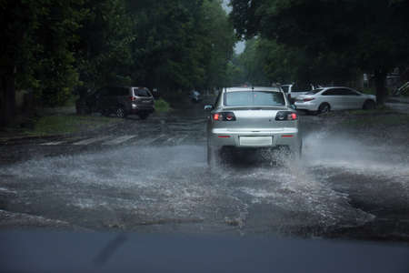 View of road with cars in evening. Rainy weather