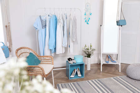 Dressing room with stylish clothes, shoes and accessories. Elegant interior designの写真素材