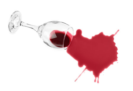 Overturned glass and spilled wine on white background, top viewの写真素材