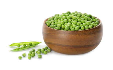 Fresh raw green peas in wooden bowl on white backgroundの写真素材