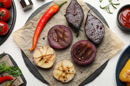 Delicious grilled vegetables served on white wooden table, flat layの写真素材