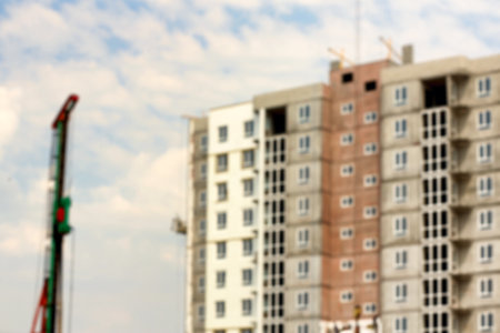 Blurred view of unfinished building and construction crane outdoorsの写真素材