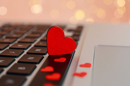Hearts on laptop keyboard, closeup. Online dating conceptの写真素材