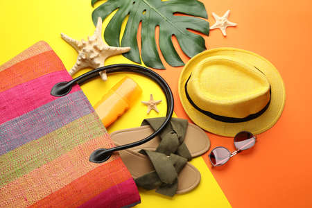 Stylish bag and beach accessories on color background, flat layの写真素材