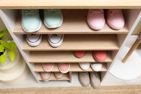 Different stylish shoes in storage unit, above view. Dressing room interiorの写真素材