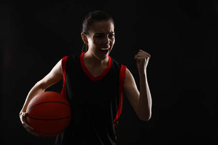 Basketball player with ball on black backgroundの写真素材