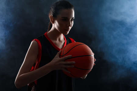 Basketball player with ball on black backgroundの写真素材