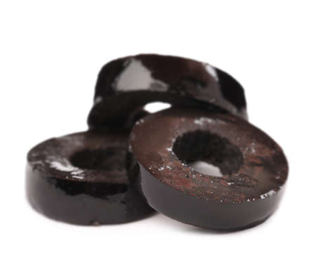 Cut fresh black olives on white backgroundの写真素材